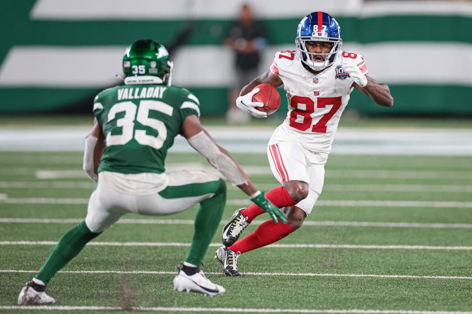 Aug 24, 2024; East Rutherford, New Jersey, USA; New York Giants wide receiver Isaiah McKenzie (87) fights for yards a s New York Jets running back Xazavian Valladay (35) pursues during the second half at MetLife Stadium. Mandatory Credit: Vincent Carchietta-USA TODAY Sports