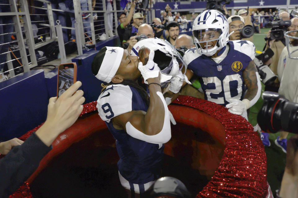 Dallas Cowboys wide receiver KaVontae Turpin (9) celebrates with running back Tony Pollard (20) after scoring a touchdown against the Washington Commanders during the second half of an NFL football game Thursday, Nov. 23, 2023, in Arlington, Texas. (AP Photo/Michael Ainsworth)