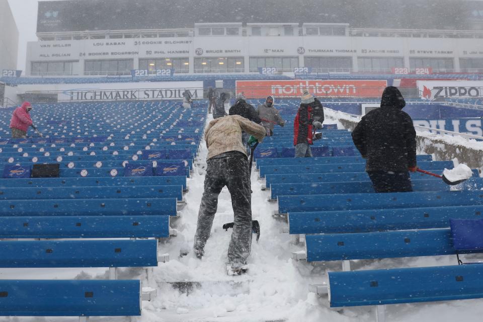 Workers remove snow from Highmark Stadium in Orchard Park, N.Y., Sunday Jan. 14, 2024. A potentially dangerous snowstorm that hit the Buffalo region on Saturday led the NFL to push back the Bills wild-card playoff game against the Pittsburgh Steelers from Sunday to Monday. New York Gov. Kathy Hochul and the NFL cited public safety concerns for the postponement, with up to 2 feet of snow projected to fall on the region over a 24- plus hour period. (AP Photo/ Jeffrey T. Barnes) ORG XMIT: NYJB104