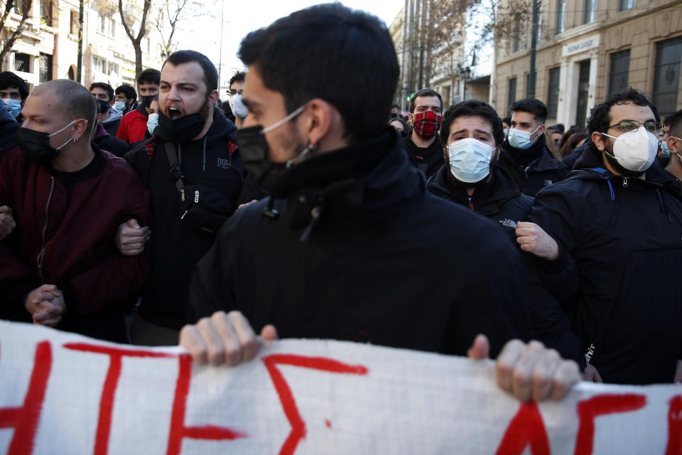 University students shout slogans during a rally against educational reforms in Athens, Thursday, Jan. 21, 2021. About 1,500 students took part in two separate protests against government's plans to set up a state security division at university campuses and time limits set for the completion of degree courses. (AP Photo/Thanassis Stavrakis)