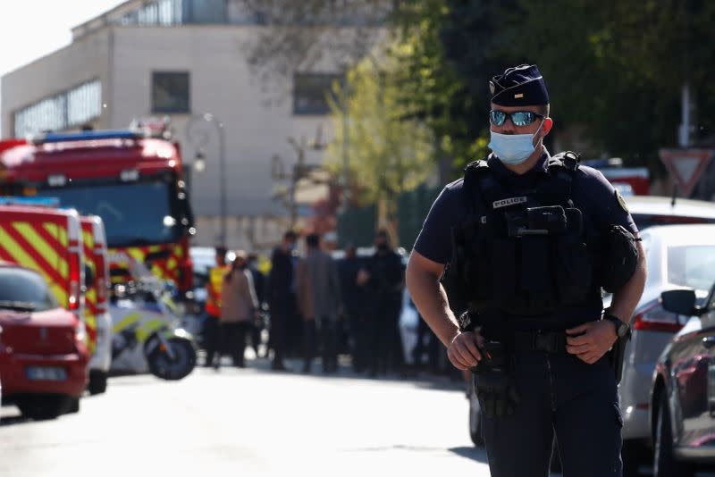 Police secure the area where an attacker stabbed a woman, in Rambouillet