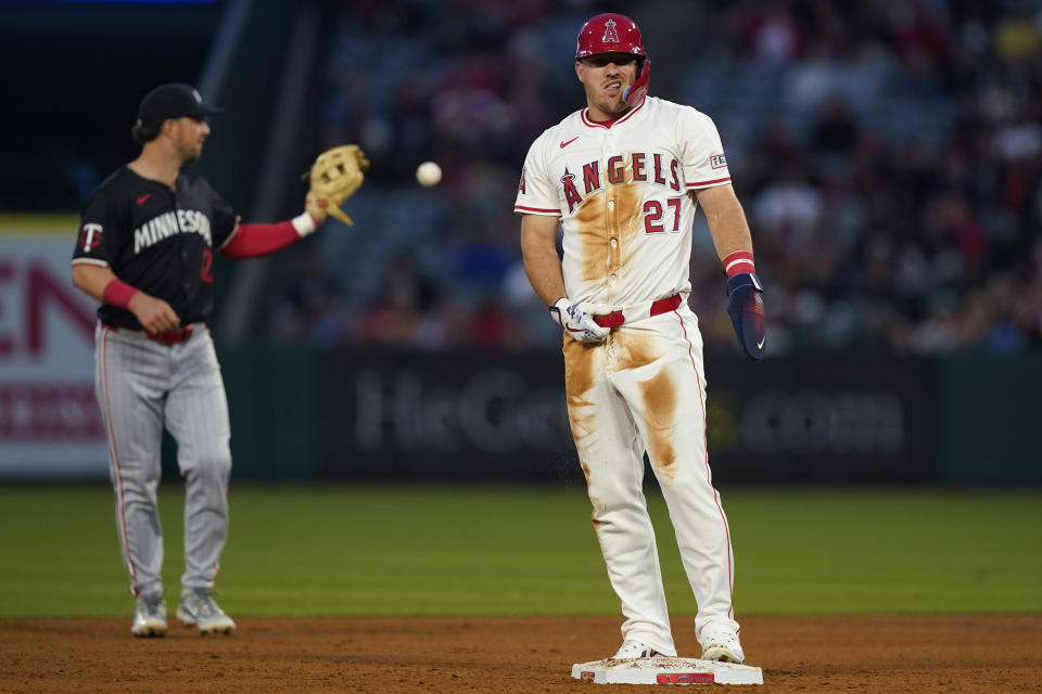 Los Angeles Angels' Mike Trout, right, reacts after being picked off by Minnesota Twins shortstop Willi Castro while trying to steal second during the fourth inning of a baseball game, Friday, April 26, 2024, in Anaheim, Calif. (AP Photo/Ryan Sun)