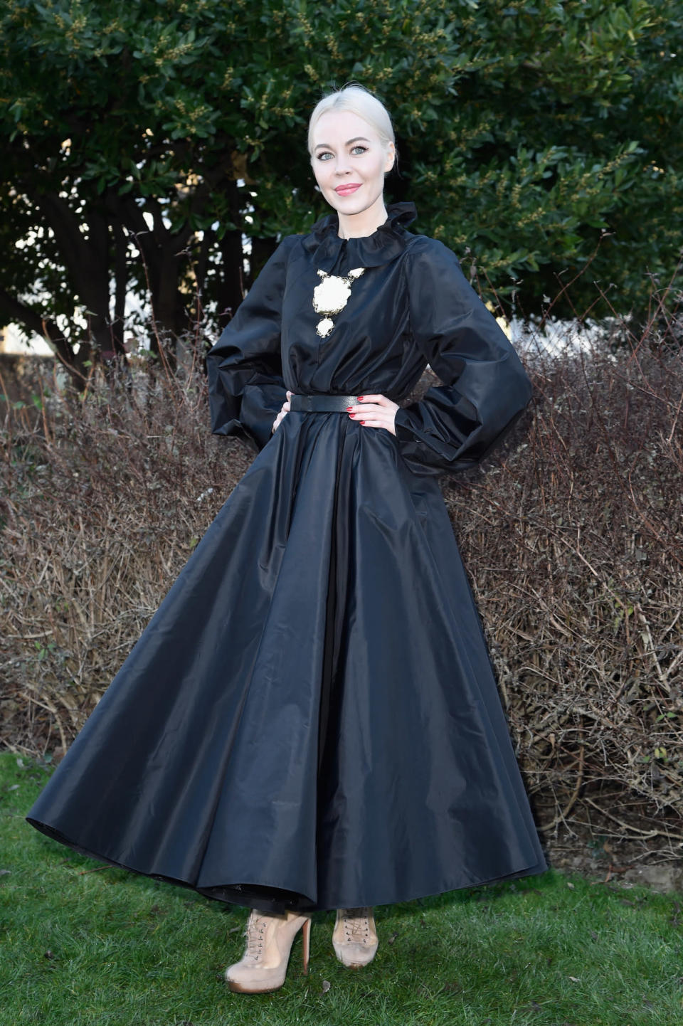 Ulyana Sergeenko in a black dress and khaki booties at the Dior spring/summer 2016 haute couture show in Paris.