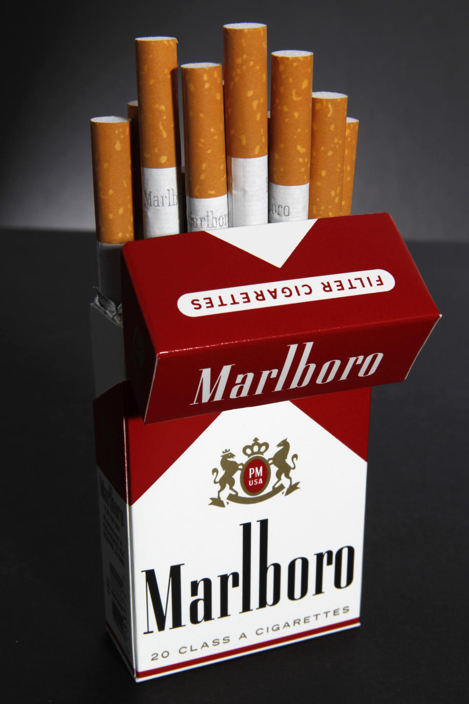 In this July 17, 2012 photo, Marlboro cigarettes are displayed in Montpelier, Vt. Marlboro maker Altria Group Inc.'s third-quarter net income fell 44 percent on charges for a loss on early extinguishment of debt. But it sold more cigarettes at higher prices and expanded its industry-leading share of the U.S. market. The owner of the nation's biggest cigarette maker, Philip Morris USA, on Thursday, Oct. 25, 2012, reported net income of $657 million, or 32 cents per share, for the three-month period ended Sept. 30, down from $1.17 billion, or 57 cents a share, a year earlier. (AP Photo/Toby Talbot)