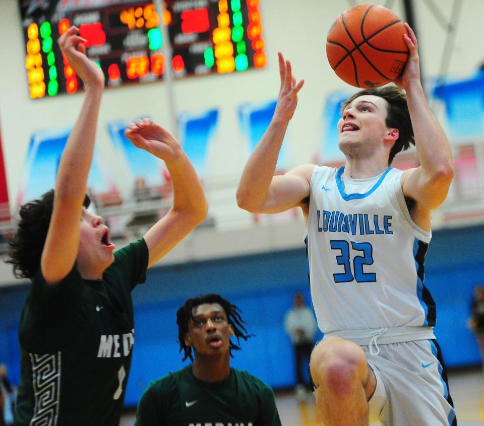 Louisville's Kolton Loy drives to the basket in a Division I district semifinal against Medina, Wednesday, March 6, 2024 at Alliance High School.