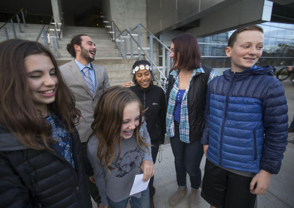 FILE - In this Nov. 10, 2016 file photo, five of the 21 youth plaintiffs in a federal climate change lawsuit against the federal government, including, from left, Sahara Valentine, 11, Jacob Lebel, 19, Avery McRae, 10, Miko Vergun, 15, Kelsey Julianna, 20, and Zealand Bell, 11, celebrate on the courthouse steps in Eugene, Ore., after U.S. District Judge Ann Aiken rejected requests from the federal government and trade groups representing many of the world's largest energy companies to dismiss their lawsuit. The U.S. government is trying once again to block a major climate change lawsuit days before young activists are set to argue at trial that the government has violated their constitutional rights by failing to take action climate change. On Thursday, Oct. 18, 2018, the Justice Department for a second time this year asked the U.S. Supreme Court to dismiss the case. The high court in July denied the request as premature. (Chris Pietsch /The Register-Guard via AP, File)