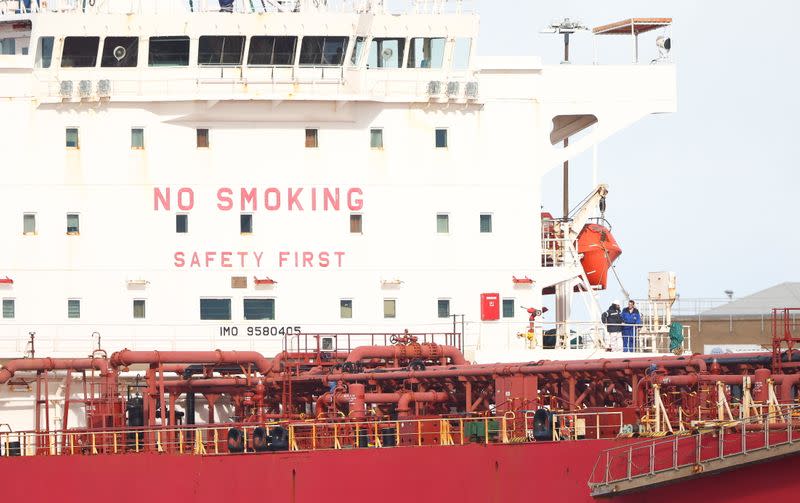 Two men are seen aboard the Liberia-flagged oil tanker Nave Andromeda at Southampton Docks, following a security incident aboard the ship the night before off the coast of Isle of Wight, in Southampton