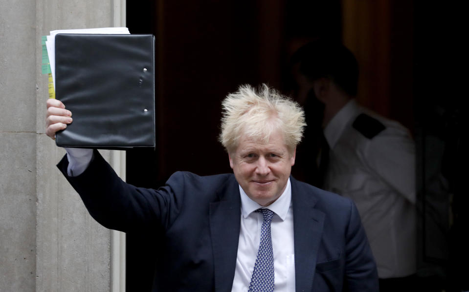 Britain's Prime Minister Boris Johnson leaves 10 Downing Street to attend the weekly Prime Ministers' Questions session, in parliament in London, Wednesday, Oct. 23, 2019. (AP Photo/Frank Augstein)