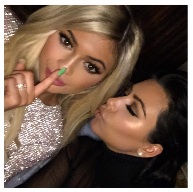 Making headlines on her first day of being 18, Jenner poses with her sister Kim Kardashian with major spider lashes and (gasp!) blonde hair.