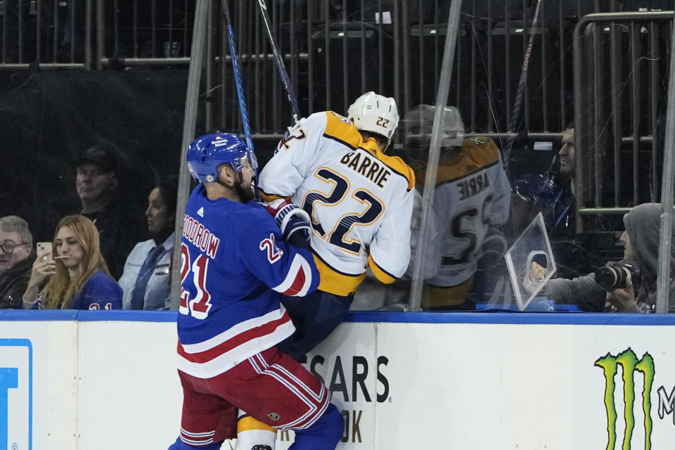 New York Rangers' Barclay Goodrow (21) checks Nashville Predators' Tyson Barrie (22) during the second period of an NHL hockey game Thursday, Oct. 19, 2023, in New York. (AP Photo/Frank Franklin II)