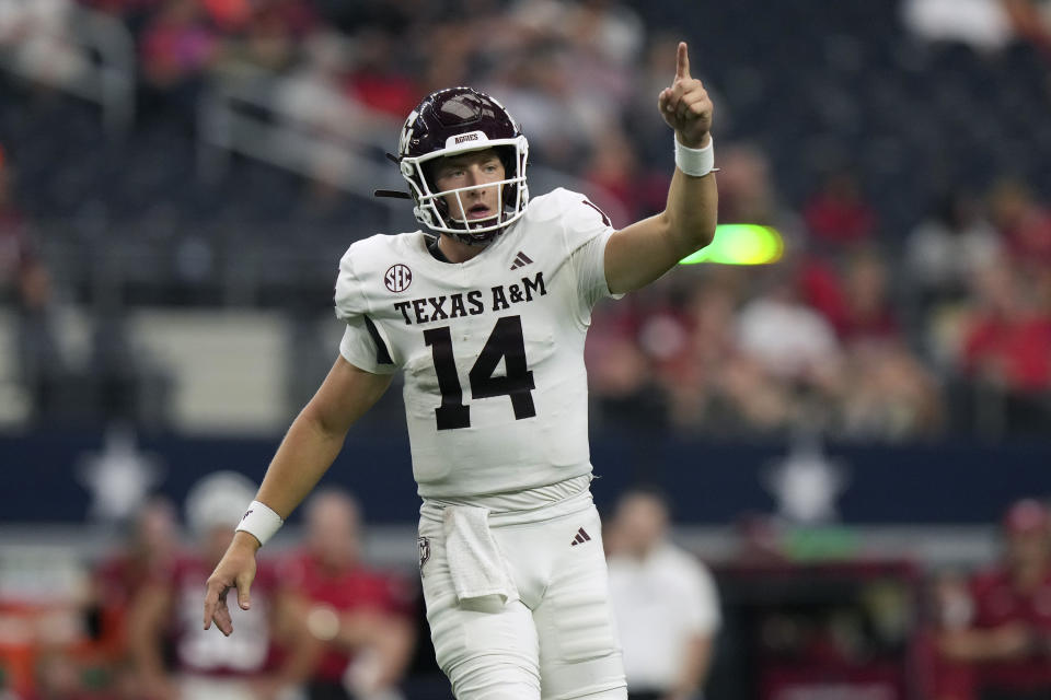 Texas A&M quarterback Max Johnson (14) raises his hand during the second half of an NCAA college football game against Arkansas, Saturday, Sept. 30, 2023, in Arlington, Texas. (AP Photo/LM Otero)