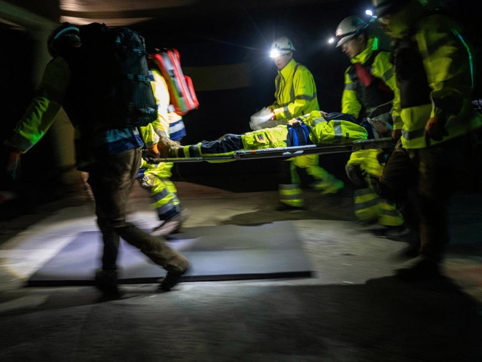 Volunteer rescuers practise the evacuation of Zaporizhia during a training exercise (AP)