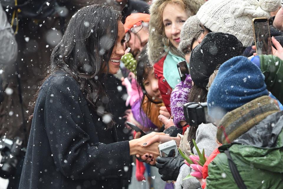 Despite the cold, Meghan opted to hold her gloves as she shook hands with fans gathered in Bristol.