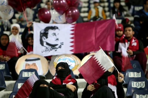 A this file picture taken on December 23, 2017 shows supporters of the Qatar national football team waving their national flags at a Gulf Cup of Nations match against Yemen in Kuwait City
