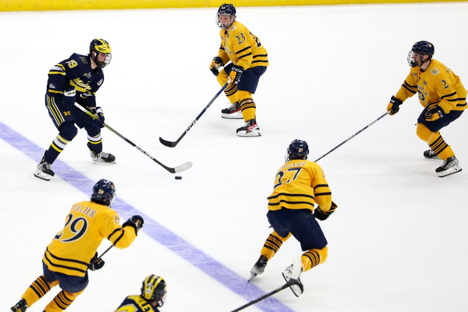 Michigan forward Adam Fantilli (19) controls the puck against Quinnipiac during the second period in the semifinals of the 2023 Frozen Four at Amalie Arena in Tampa, Florida, on Thursday, April 6, 2023.