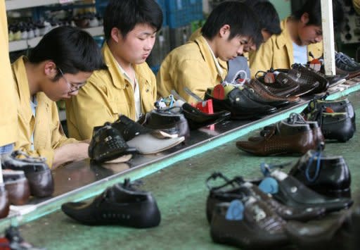 File picture of factory workers checking shoes for flaws on a production line at the Kangnai shoe factory in Wenzhou. China's leaders are sliding their toes further into the tide of economic reform, exciting ripples of cautious optimism in the United States, where Wall Street and Main Street could benefit