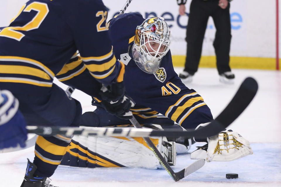 Buffalo Sabres goalie Carter Hutton (40) covers the puck during the first period of an NHL hockey game against the Toronto Maple Leafs, Sunday, Feb. 16, 2020, in Buffalo, N.Y. (AP Photo/Jeffrey T. Barnes)