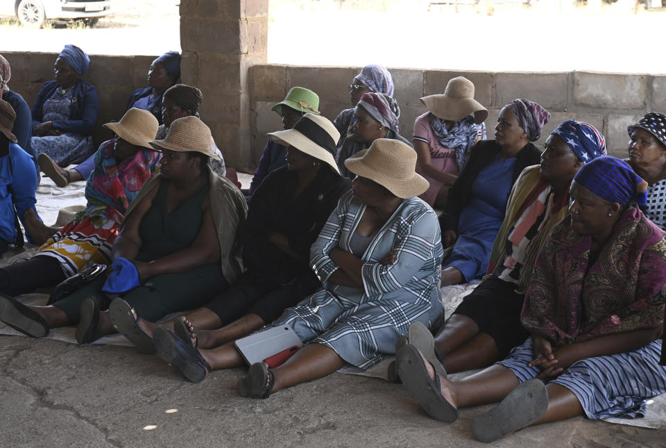 Family members and friends of the bus crash victims gather at the ZCC Church, where victims used for church services in the Molepolole village near Gaborone, Botswana, Friday, March 29, 2024. A bus carrying Easter pilgrims from Botswana to Moria in South Africa crashed en route in Mokopane, South Africa, claiming the lives of some 45 people. An 8-year-old survived. (AP Photo)