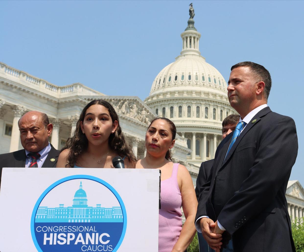 Estela Juarez of Polk County speaks Tuesday during a news conference at the U.S. Capitol as her mother, Alejandra Juarez, stands behind her shoulder. Rep. Darren Soto, D-Kissimmee, shown at right, co-introduced the Protect Patriot Spouses Act.