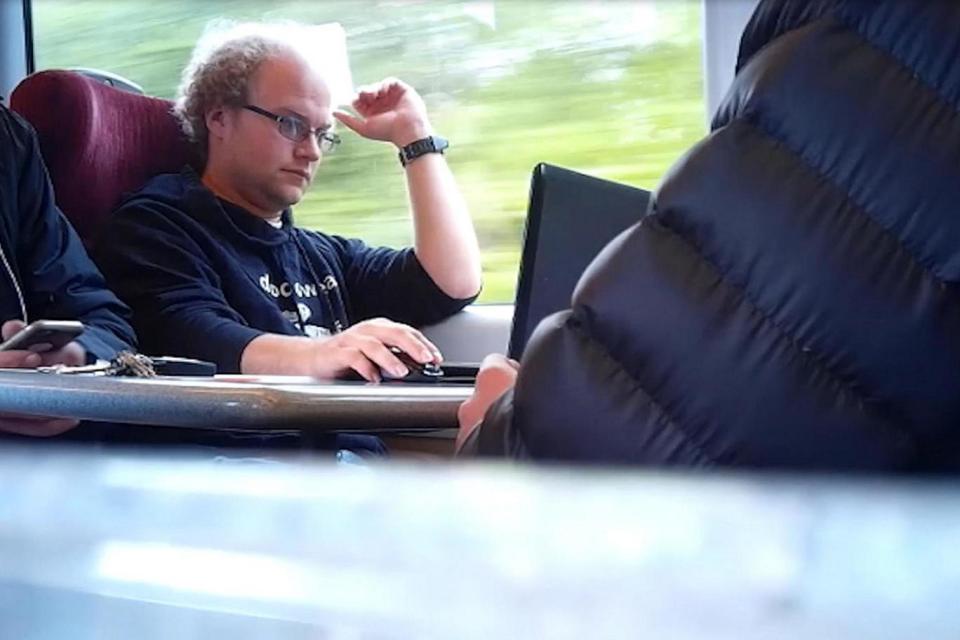 Surveillance footage of Matthew Falder on a train (PA)