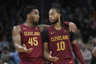 Cleveland Cavaliers' Donovan Mitchell (45) and Darius Garland (10) talk near the end of the second half of an NBA basketball game against the Indiana Pacers in Cleveland, Friday, April 12, 2024. (AP Photo/Phil Long)