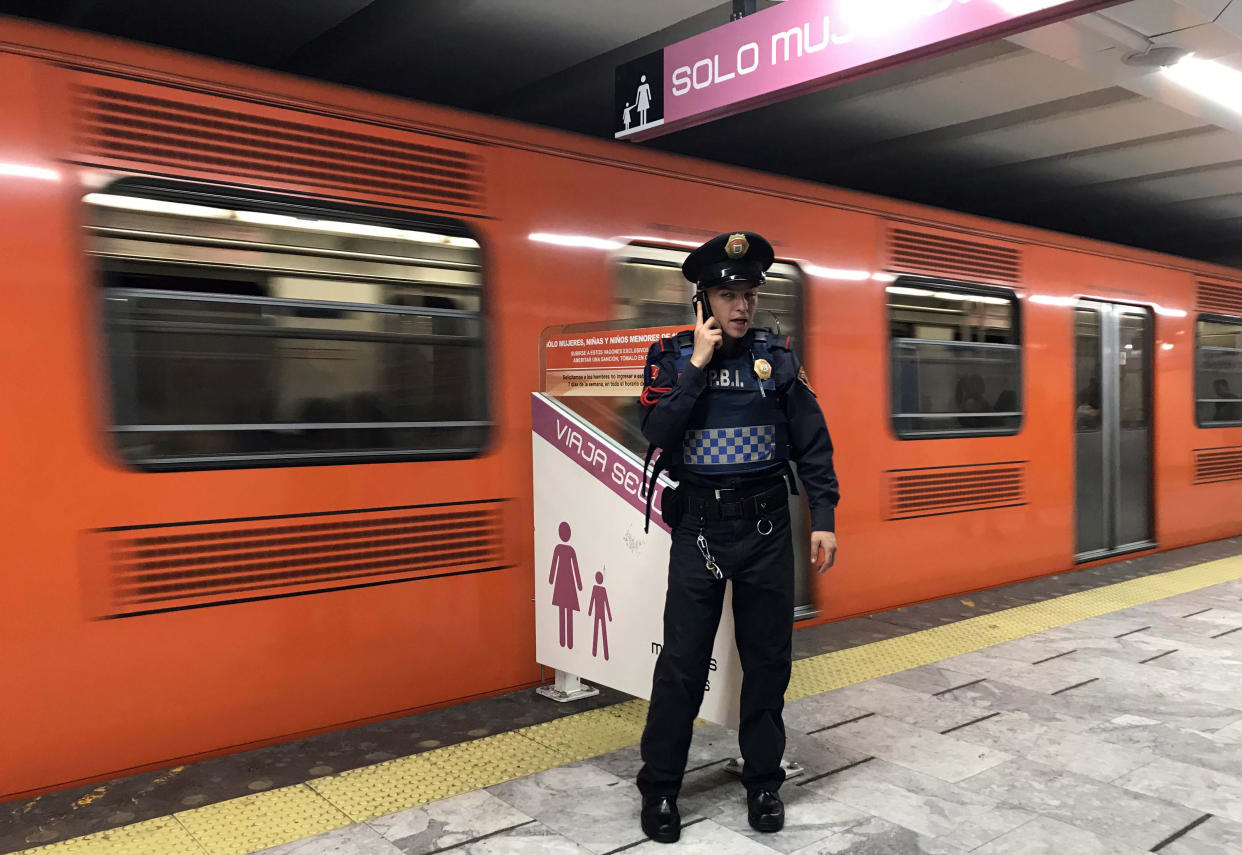 A police officer stands guard at an exclusive boarding area for women and children under twelve years old, at Pino Suarez subway station in Mexico City on February 07, 2019. - Along with the violence linked to drug trafficking, femicides in Mexico have been increasing. According to the UN, nine women are killed every day in Mexico, and six out of ten have faced some kind of aggression, many of them in public transport. (Photo by ALFREDO ESTRELLA / AFP)        (Photo credit should read ALFREDO ESTRELLA/AFP via Getty Images)