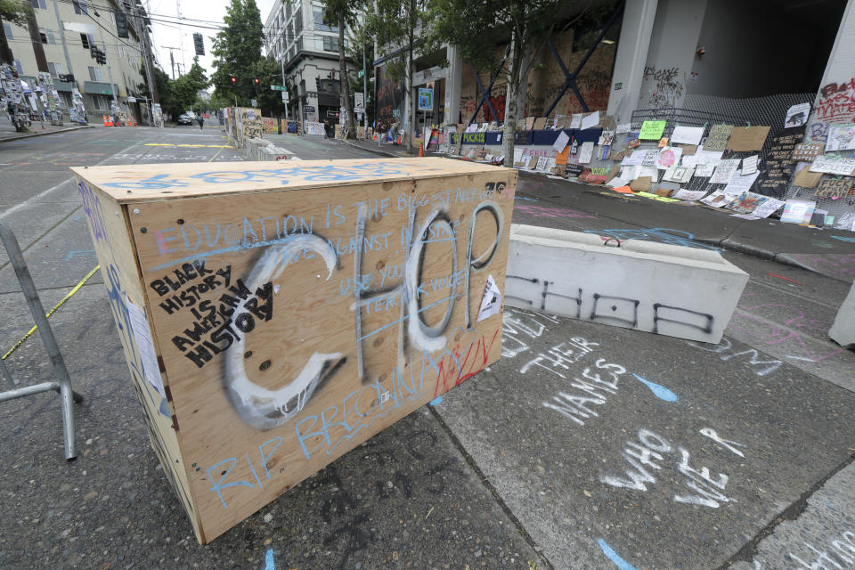 CHOP is spray painted on a barricade, Saturday, June 20, 2020, inside what has been named the Capitol Hill Occupied Protest zone in Seattle. A pre-dawn shooting near the area left one person dead and critically injured another person, authorities said Saturday. The area has been occupied by protesters after Seattle Police pulled back from several blocks of the city's Capitol Hill neighborhood near the Police Department's East Precinct building. (AP Photo/Ted S. Warren)