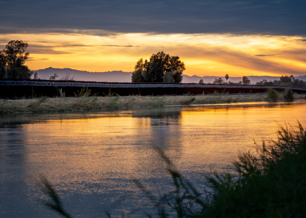 The sun setting at the Mexico border near Calexico and Mexicali.