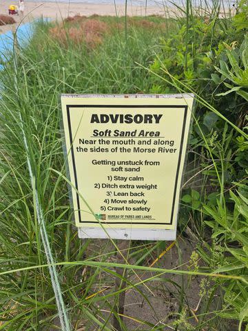 <p>Jamie Acord</p> A new sign at Popham Beach State Park warning visitors about soft sand, after Jamie Acord fell into sand on June 1, 2024