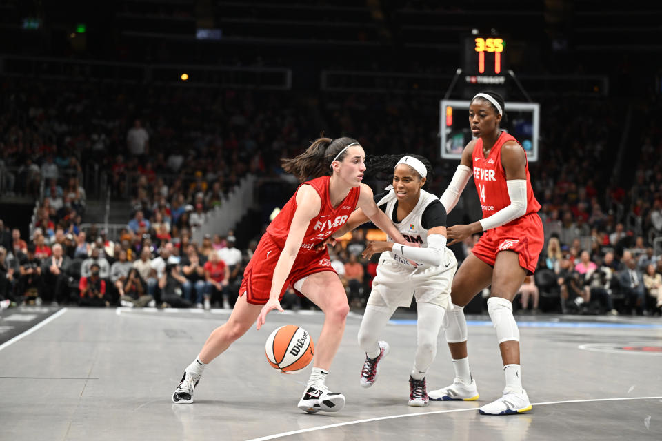 ATLANTA, GEORGIA - AUGUST 26: Caitlin Clark #22 of the Indiana Fever handles the ball as Jordin Canada #3 of the Atlanta Dream plays defense on August 26, 2024 at State Farm Arena in Atlanta, Georgia. NOTE TO USER: User expressly acknowledges and agrees that, by downloading and or using this photograph, User is consenting to the terms and conditions of the Getty Images License Agreement. (Photo by Paras Griffin/Getty Images)