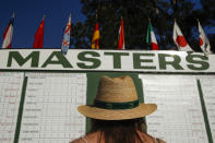 FILE - In this April 5, 2018, file photo, Anna Lee Lavarnway looks at the leaderboard during the first round at the Masters golf tournament in Augusta, Ga. Augusta National decided Friday, March 13, 2020, to postpone the Masters because of the spread of the coronavirus. Club chairman Fred Ridley says he hopes postponing the event puts Augusta National in the best position to host the Masters and its other two events at some later date. Ridley did not say when it would be held. (AP Photo/Charlie Riedel, File)