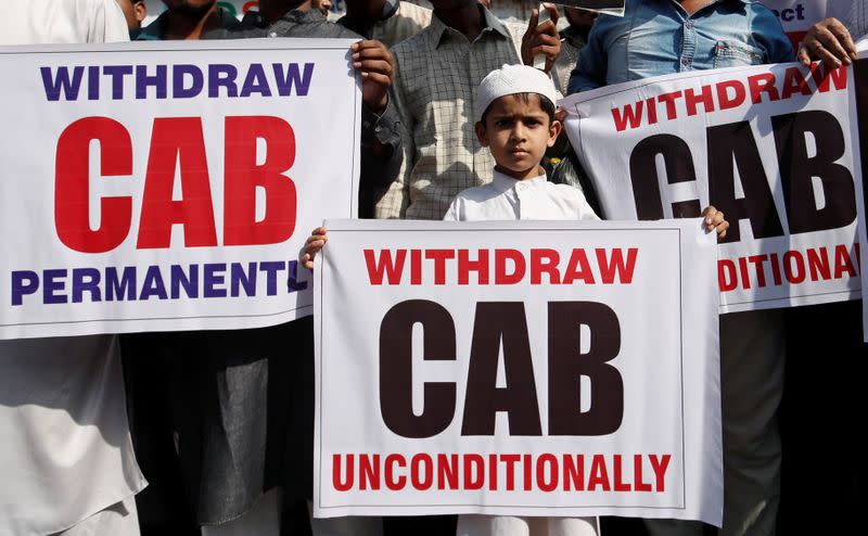 A boy holds a placard during a protest against the Citizenship Amendment Bill in Mumbai