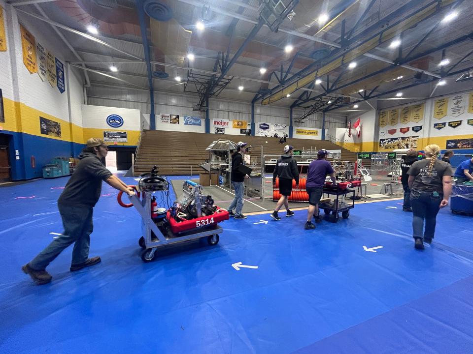 Robotics teams from various high schools prepare their machines to use in the competition area before matches begin for the FIRST Robotics competition at LSSU on March 14, 2024.