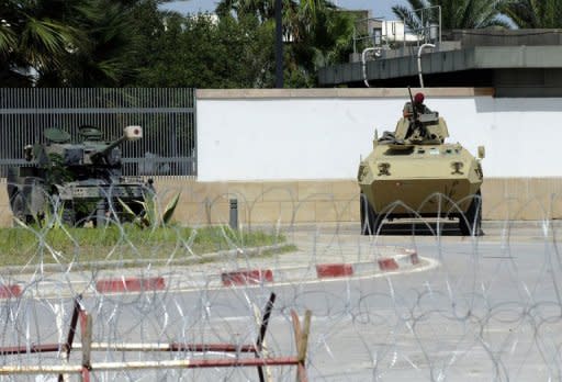 Tunisian soldiers guard the US embassy building in Tunis. Al-Qaeda called for fresh attacks against US targets in the Arab world and the West, as Washington said it was pulling non-essential embassy staff out of Sudan and Tunisia