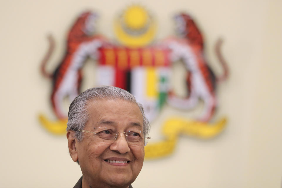 Malaysian Prime Minister Mahathir Mohamad smiles during a press conference in Putrajaya, Malaysia, Monday, April 15, 2019. Malaysia's government decided to resume a China-backed rail link project, after the Chinese contractor agreed to cut the construction cost by one-third. (AP Photo/Vincent Thian)