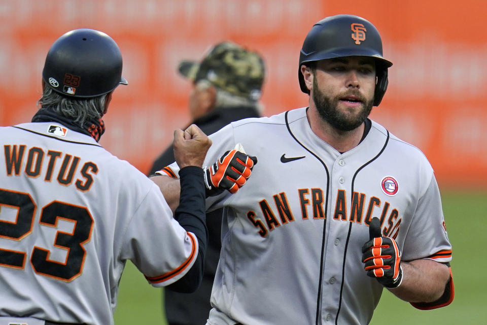 San Francisco Giants' Darin Ruf, right, rounds third to greetings from third base coach Ron Wotus (23) after hitting a solo home run off Pittsburgh Pirates starting pitcher Tyler Anderson during the first inning of a baseball game in Pittsburgh, Saturday, May 15, 2021. (AP Photo/Gene J. Puskar)