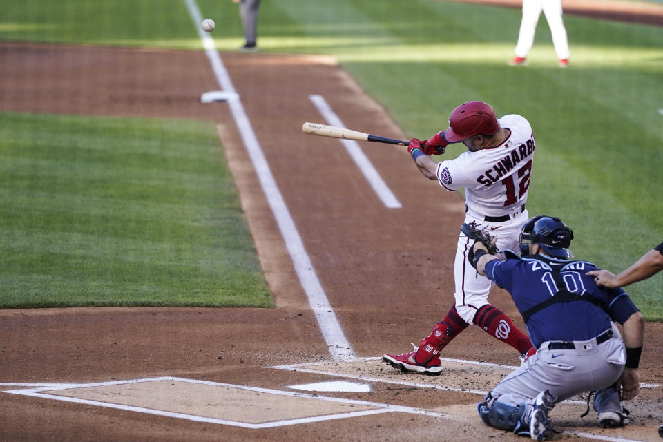 Washington Nationals' Kyle Schwarber hits a solo home run during the first inning of a baseball game against the Tampa Bay Rays at Nationals Park, Tuesday, June 29, 2021, in Washington. (AP Photo/Alex Brandon)