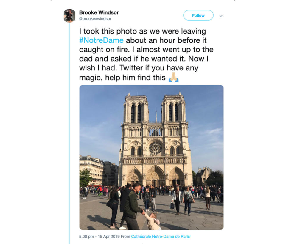 A man and child believed to be dad and daughter pictured out the front of the Notre Dame Cathedral an hour before the fire. Source: Brooke Windsor/Twitter