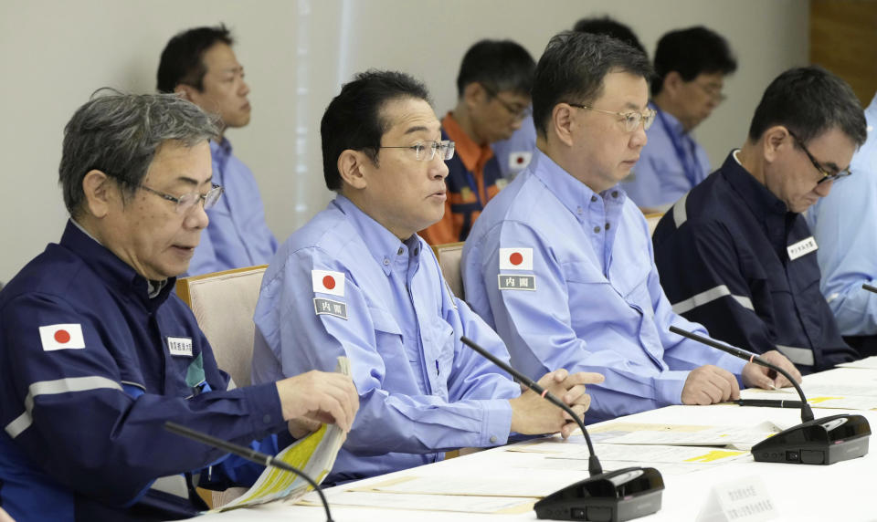 Japanese Prime Minister Fumio Kishida, second left, speaks during a disaster drill at his office in Tokyo Friday, Sept. 1, 2023. On Friday, Japan marked the centennial of the 1923 Great Kanto Quake that killed more than 100,000. (Kyodo News via AP)