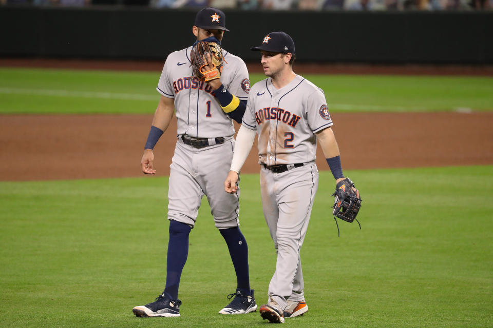 SEATTLE, WASHINGTON - SEPTEMBER 21: Carlos Correa #1 and Alex Bregman #2 of the Houston Astros have a conversation in the seventh inning against the Seattle Mariners at T-Mobile Park on September 21, 2020 in Seattle, Washington. (Photo by Abbie Parr/Getty Images)