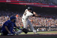 San Francisco Giants' Darin Ruf, right, hits an RBI-single in front of Los Angeles Dodgers catcher Will Smith during the second inning of a baseball game in San Francisco, Sunday, Sept. 5, 2021. (AP Photo/Jeff Chiu)