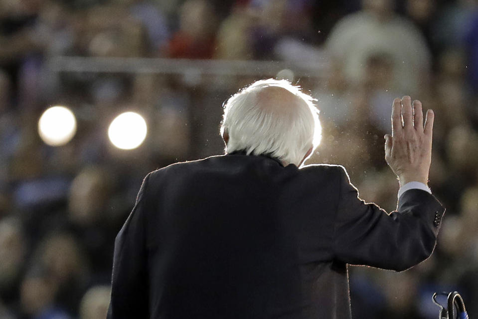 Democratic presidential candidate Sen. Bernie Sanders I-Vt., is lit by spotlights as he speaks at a campaign event in Tacoma, Wash., Monday, Feb. 17, 2020. (AP Photo/Ted S. Warren)