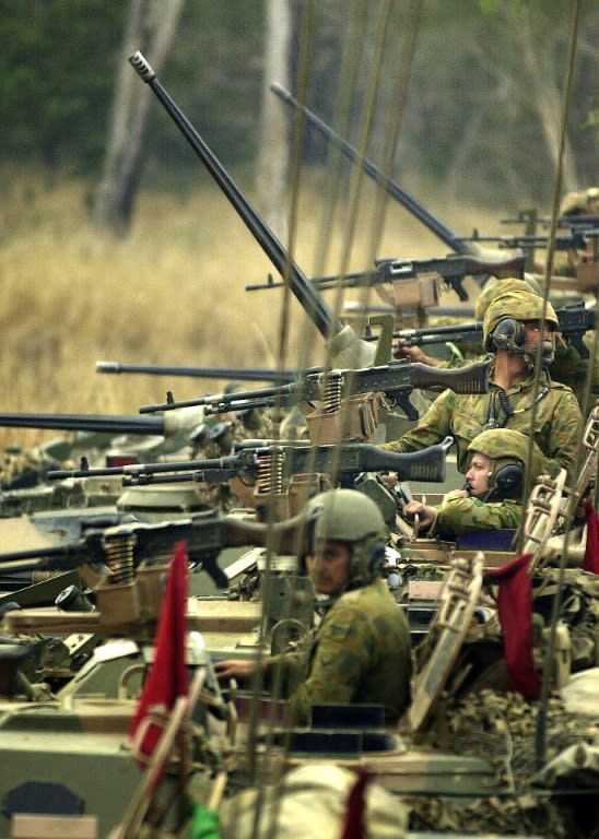 Australian Army light armoured vehicles prepare to attack during Exercise Predator's Gallop, at Shoalwater Bay, in 2003