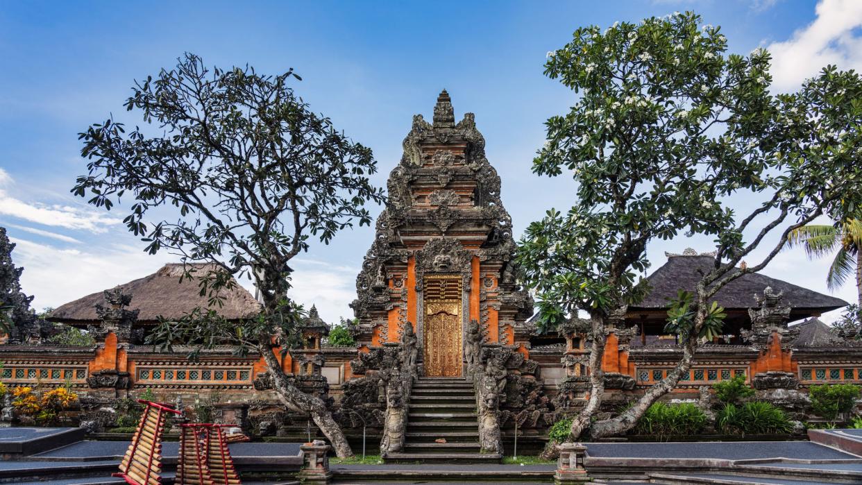 Bali Hindu Temple - Ubud Water Palace Panorama. Majestic Hindu Pura Taman Kemuda Saraswati Temple in Ubud under blue summer sky. Ubud, Bali Island, Indonesia, South-East Asia, Asia