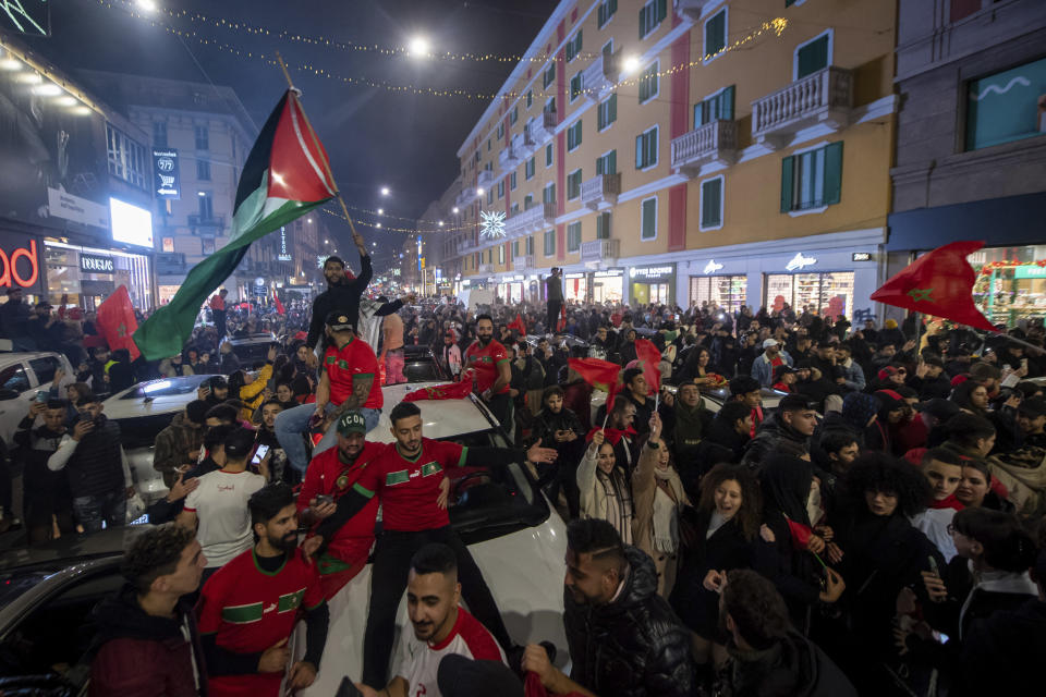 Morocco fans celebrate in Milan, Italy, after their victory against Spain in the World Cup round of 16 soccer match between Morocco and Spain, Tuesday, Dec. 6, 2022. (Claudio Furlan/Lapresse via AP)