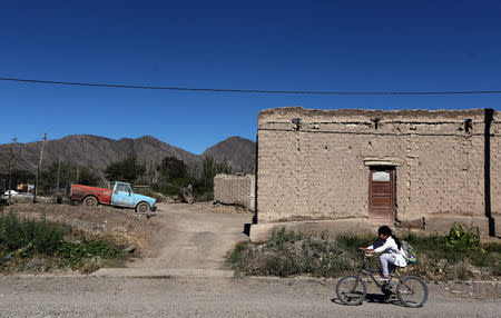 A girl rides her bicycle in Jachal, a town that may have been affected by the cyanide spill at the nearby Barrick Gold Corp's Veladero gold mine, San Juan province, Argentina, April 27, 2017. REUTERS/Marcos Brindicci