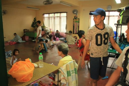 Residents rest inside a classroom used as a temporary shelter in Legaspi City, Albay province, south of Manila