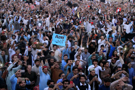 Members of the Pakistan's Pashtun community, chant slogans and take photos of their leader Manzoor Pashteen (unseen) during Pashtun Tahaffuz Movement's (PTM) rally against, what they say, are human rights violations, in Lahore, Pakistan April 22, 2018. REUTERS/Mohsin Raza