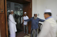 A Sri Lankan Muslim guides people for Friday prayers inside a mosque, in Colombo, Sri Lanka, Friday, April 26, 2019. Across Colombo, there was a visible increase of security as authorities warned of another attack and pursued suspects that could have access to explosives. Authorities had told Muslims to pray at home rather than attend communal Friday prayers that are the most important religious service for the faithful. At one mosque in Colombo where prayers were still held, police armed with Kalashnikov assault rifles stood guard outside. (AP Photo/Manish Swarup)