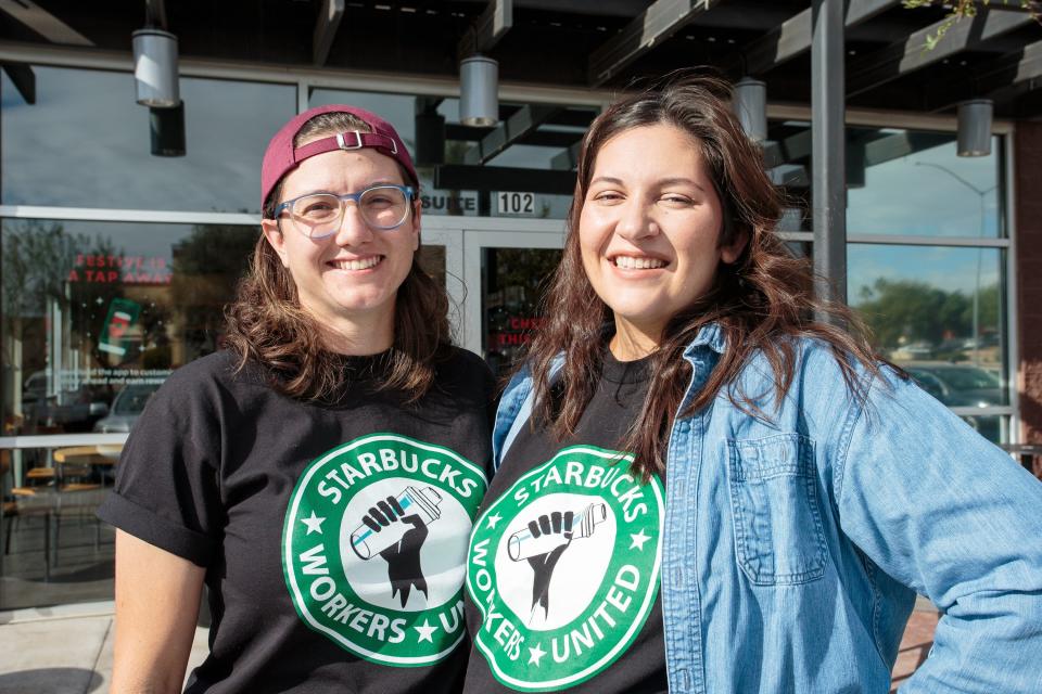 Shift supervisors Michelle Hejduk (left) and Liz Alanna stand outside their store in Mesa, Arizona on Dec. 15, 2021, wearing shirts that read "Starbucks Workers United" after having filed for a union election to be the first Starbucks in Arizona to form a union.